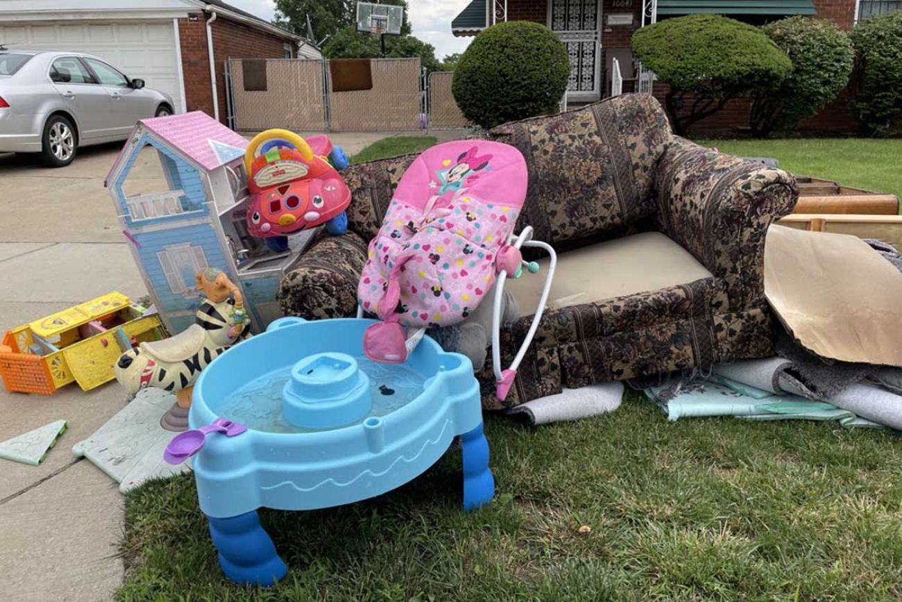 Furniture piled up in front of a home in Dearborn’s Southend neighborhood following flooding in late June