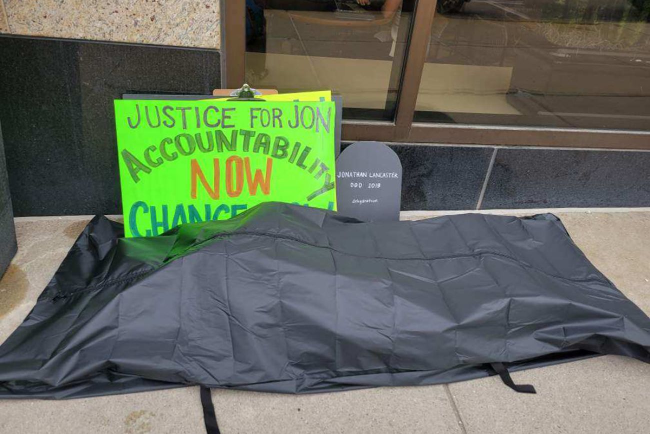 body bag along with a sign calling for accountability 