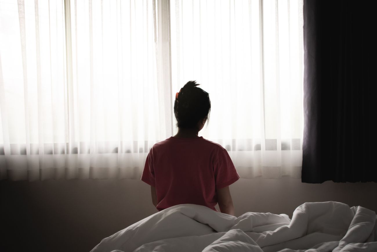 woman sitting alone in a bed