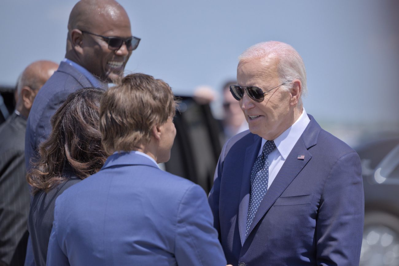 Joe Biden, wearing a blue suit, talking to people