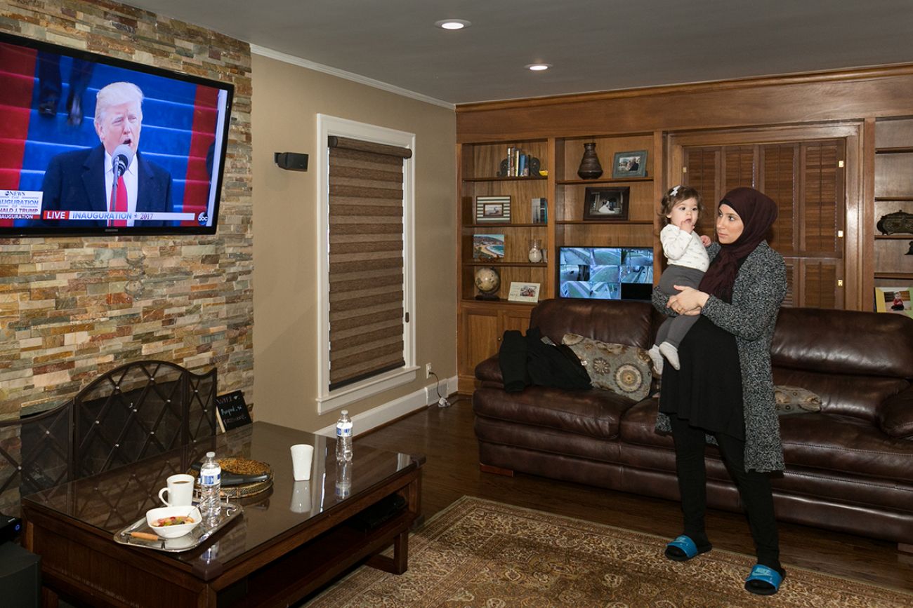 Mariam Charara watches the inauguration at her home in Dearborn