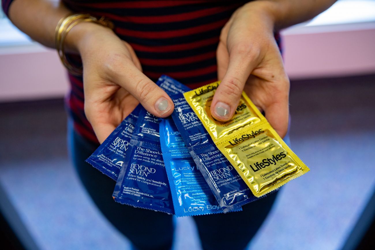 holding condoms