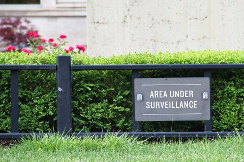 sign that says "area under surveillance"