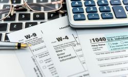 tax forms with with laptop and calculator