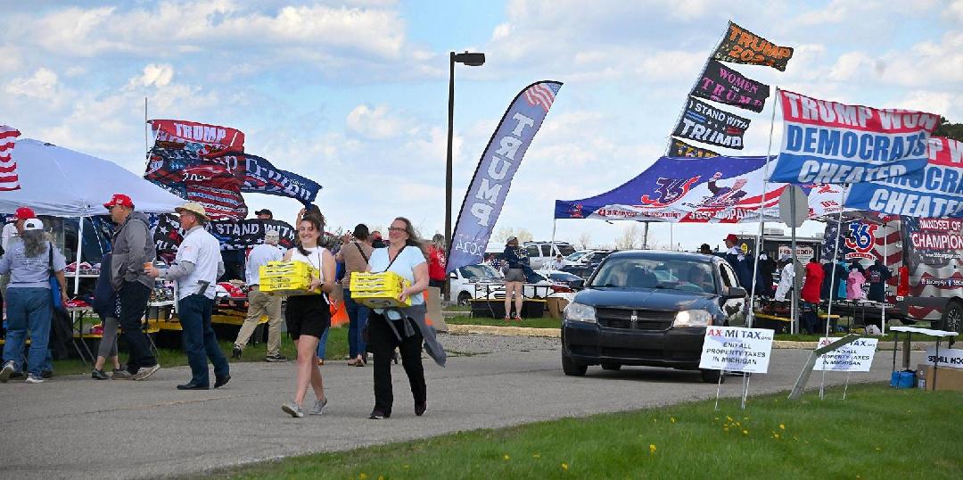 Supporters of former President Donald Trump prepare for his rally in Freeland, Michigan. (Bridge photo by Dale Young)