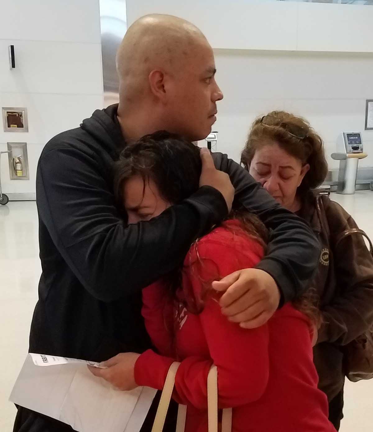 Maria hugs her husband