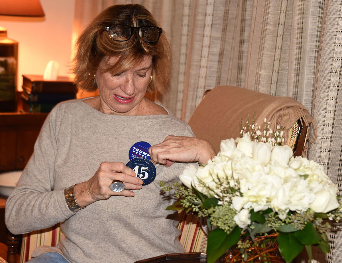 Cindy Schaffer putting on a Trump button.
