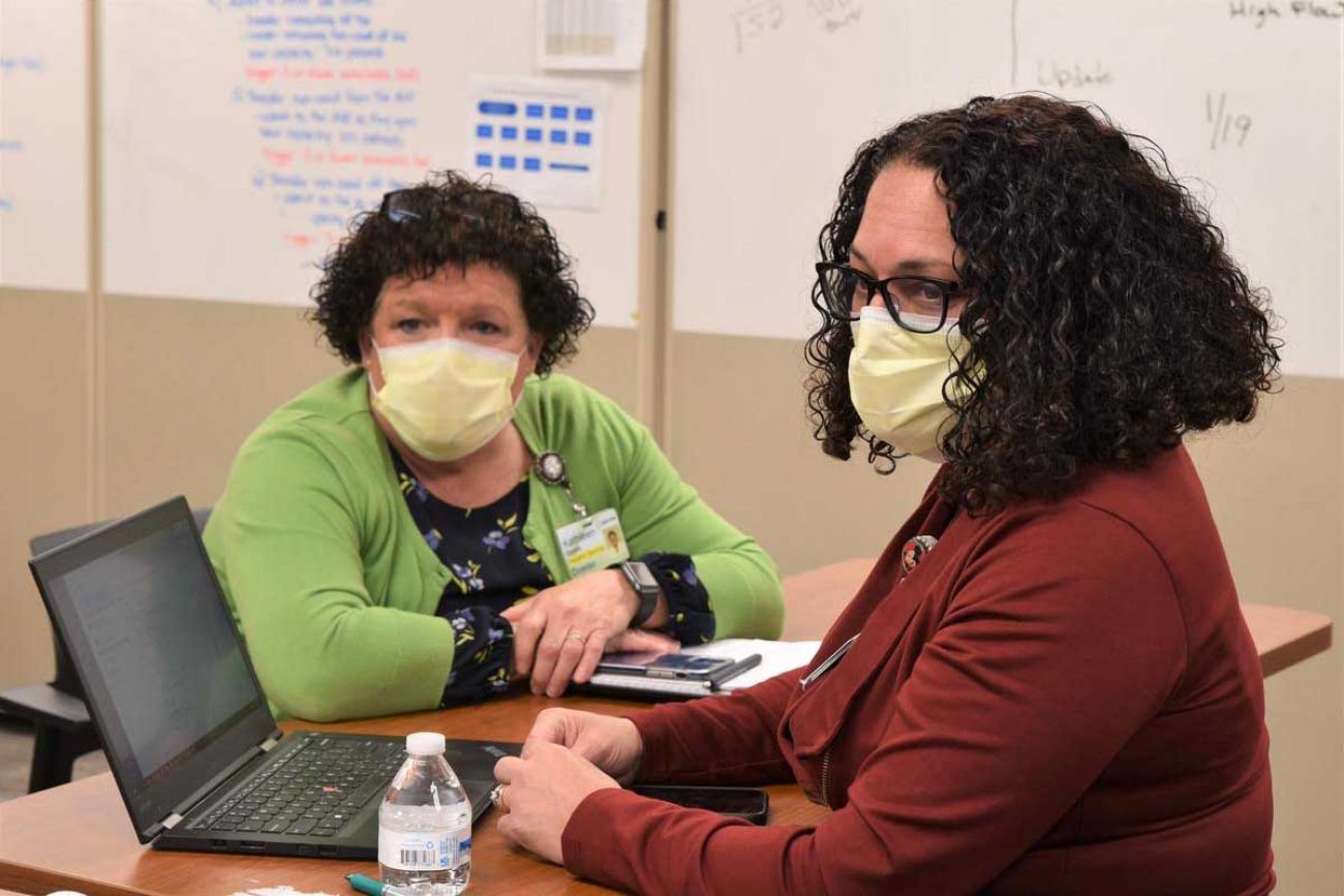 Kathleen Marble, nursing director for pediatric services, and Jeanne Bishop, director of nursing operations, discuss where to put all the kids and infants coming into Sparrow Hospital with COVID-19.