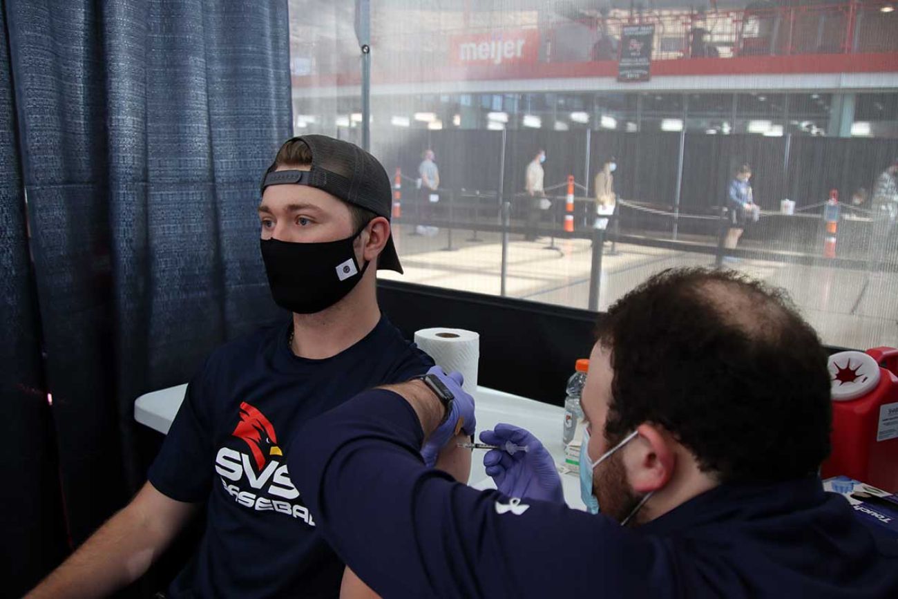 Saginaw Valley State University student Matt Montroy gets a COVID-19 vaccine shot on campus