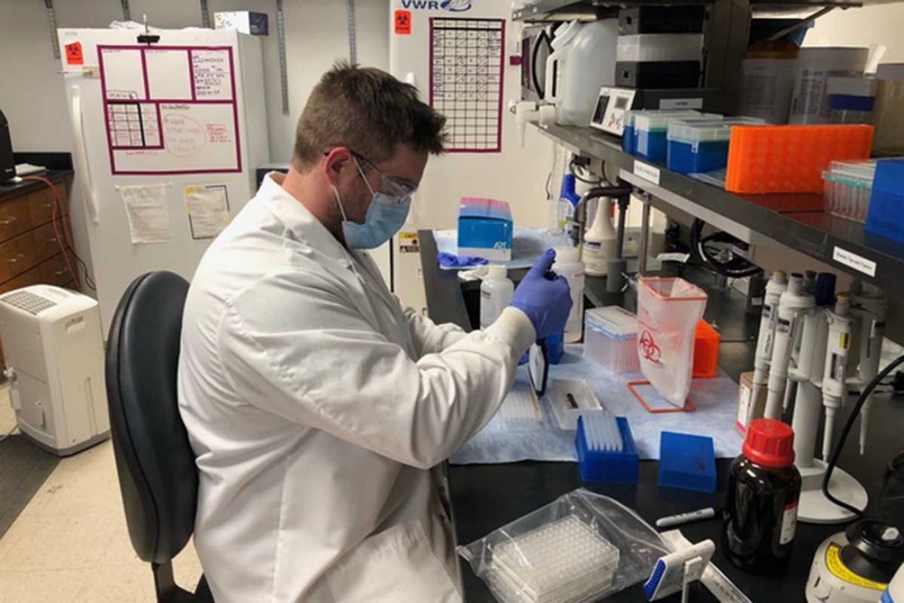 Chris Blair, a lab tech, prepares coronavirus samples for sequencing at the University of Michigan.
