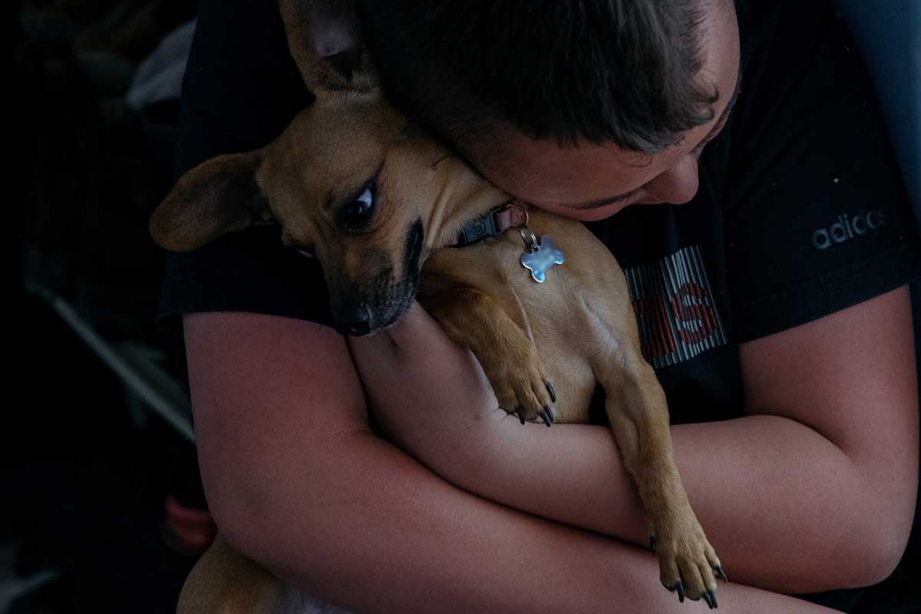 A teenager in southeast Michigan hugs his dog