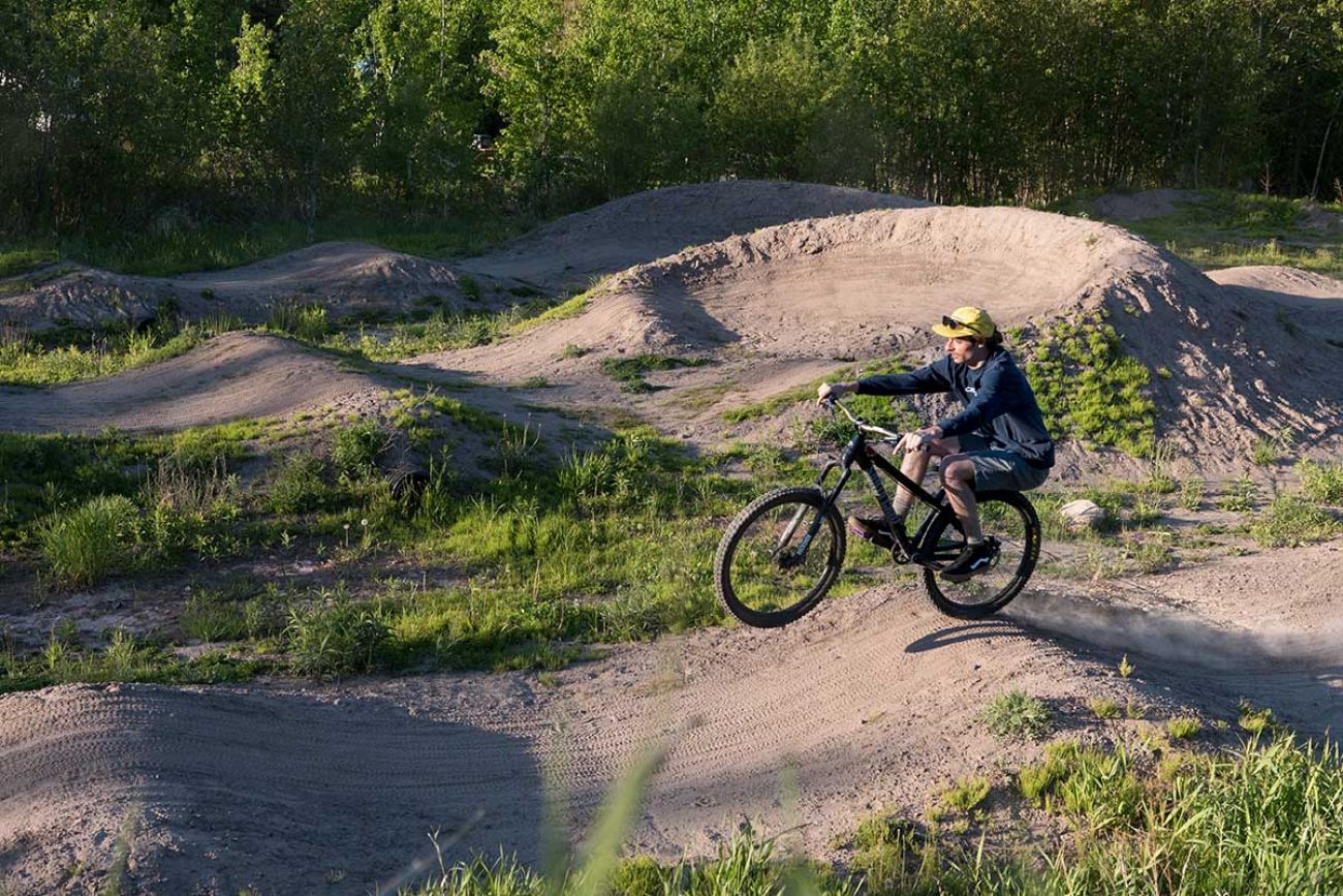 Ian DeVlieg rolls through a pump track at the Trails End Campground west of downtown Copper Harbor.