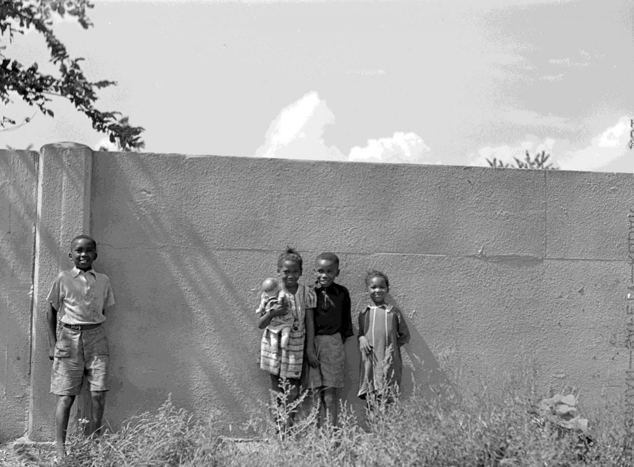 Children stand in front of the Birwood Wall in August 1941