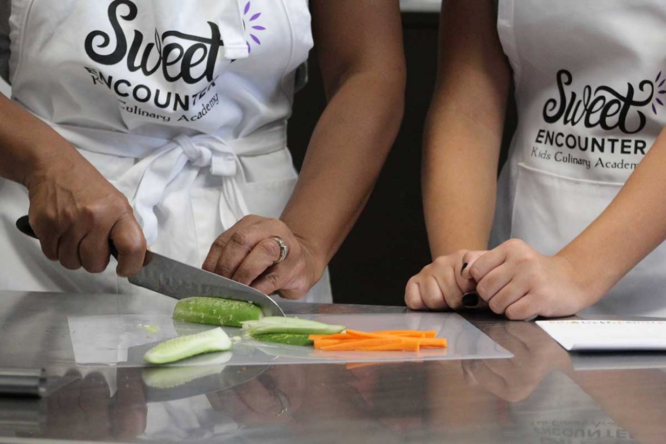 Nikki Thompson Frazier cutting cucumbers