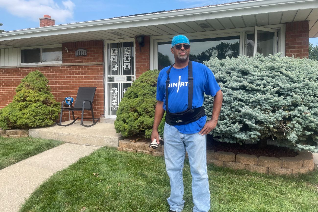 Bernard Cox poses in front of his Eastpointe home