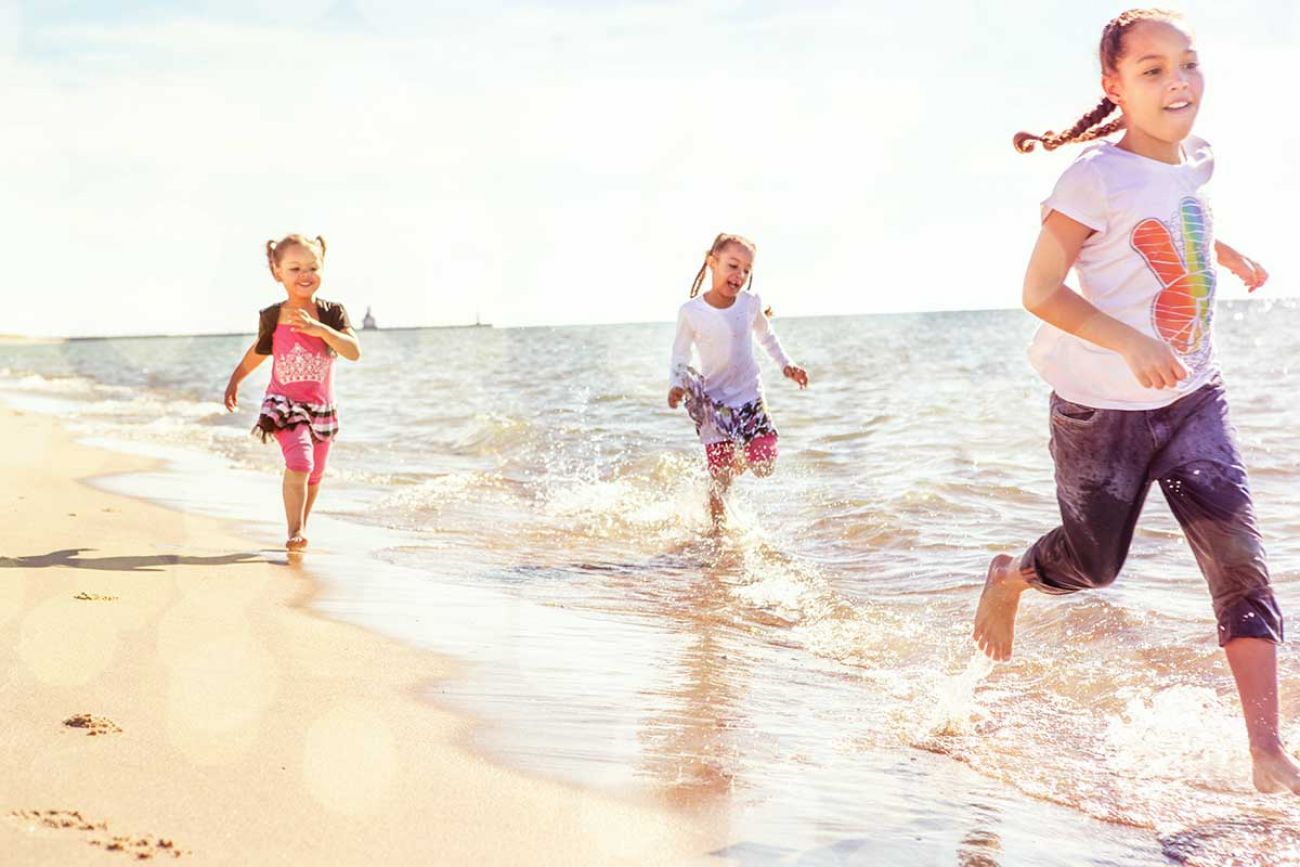 kids running on the beach