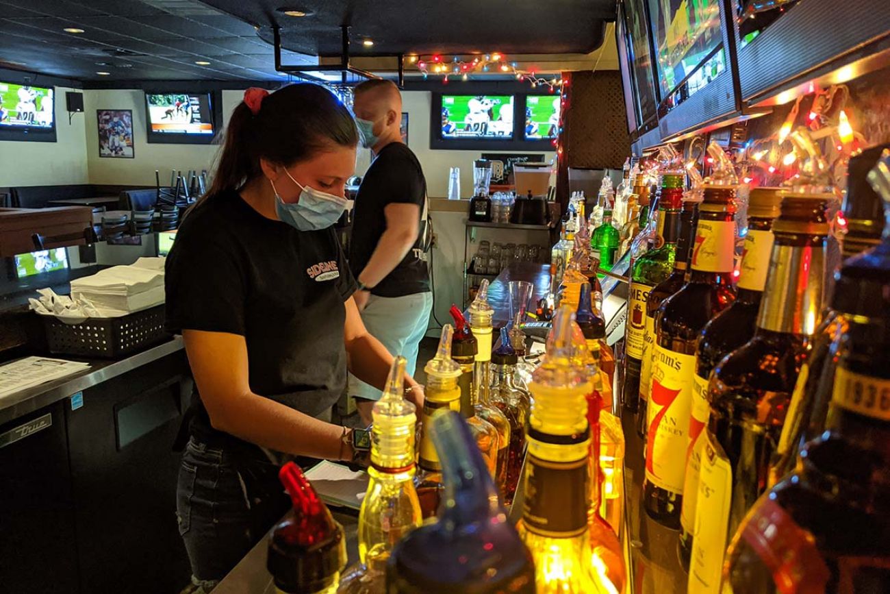 person in mask in bar