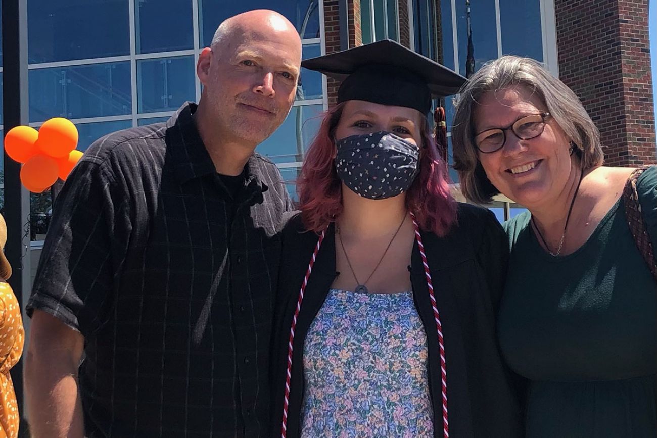 Tim Fournier, left, and Ingrid Fournier, right, stand with their daughter. 