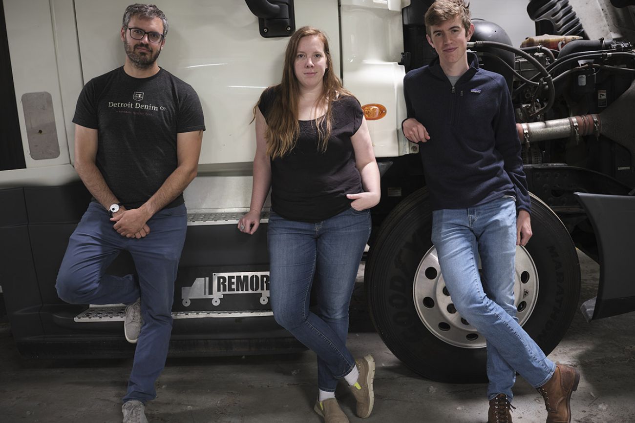 three people in front of the truck