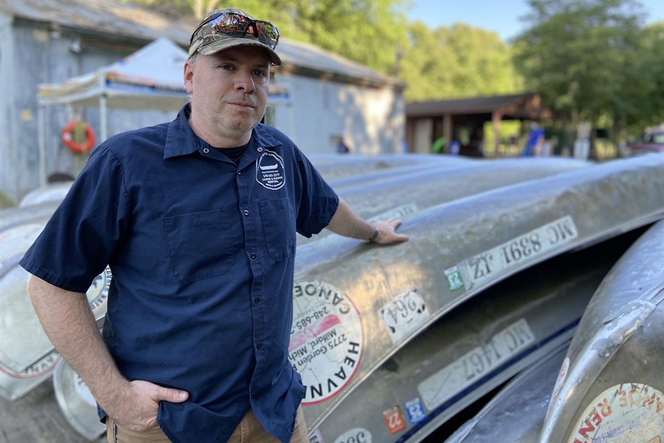 Bruce Heavner standing by canoe