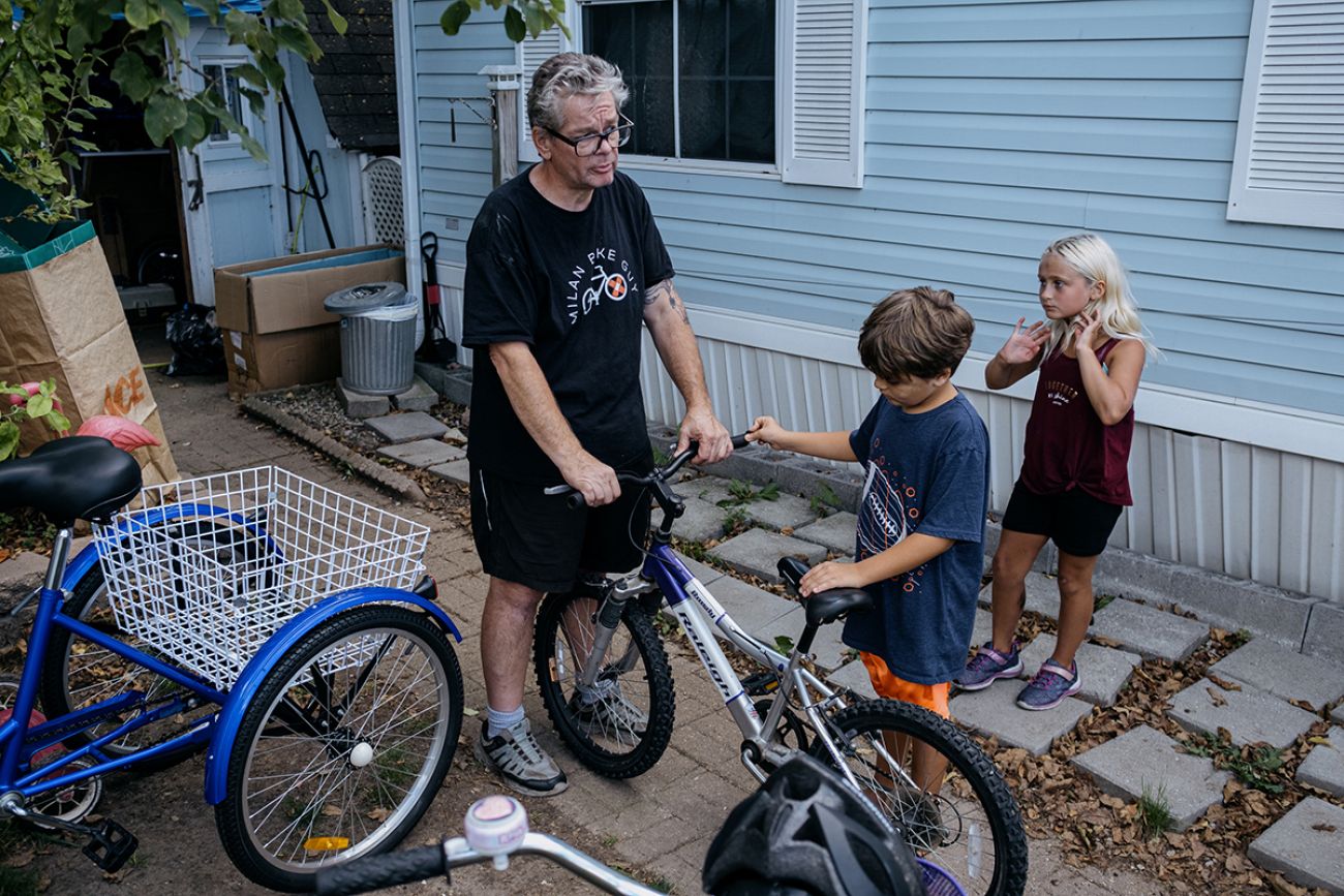 adult to two children with bike