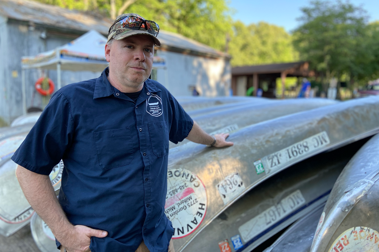 Bruce Heavner near canoes