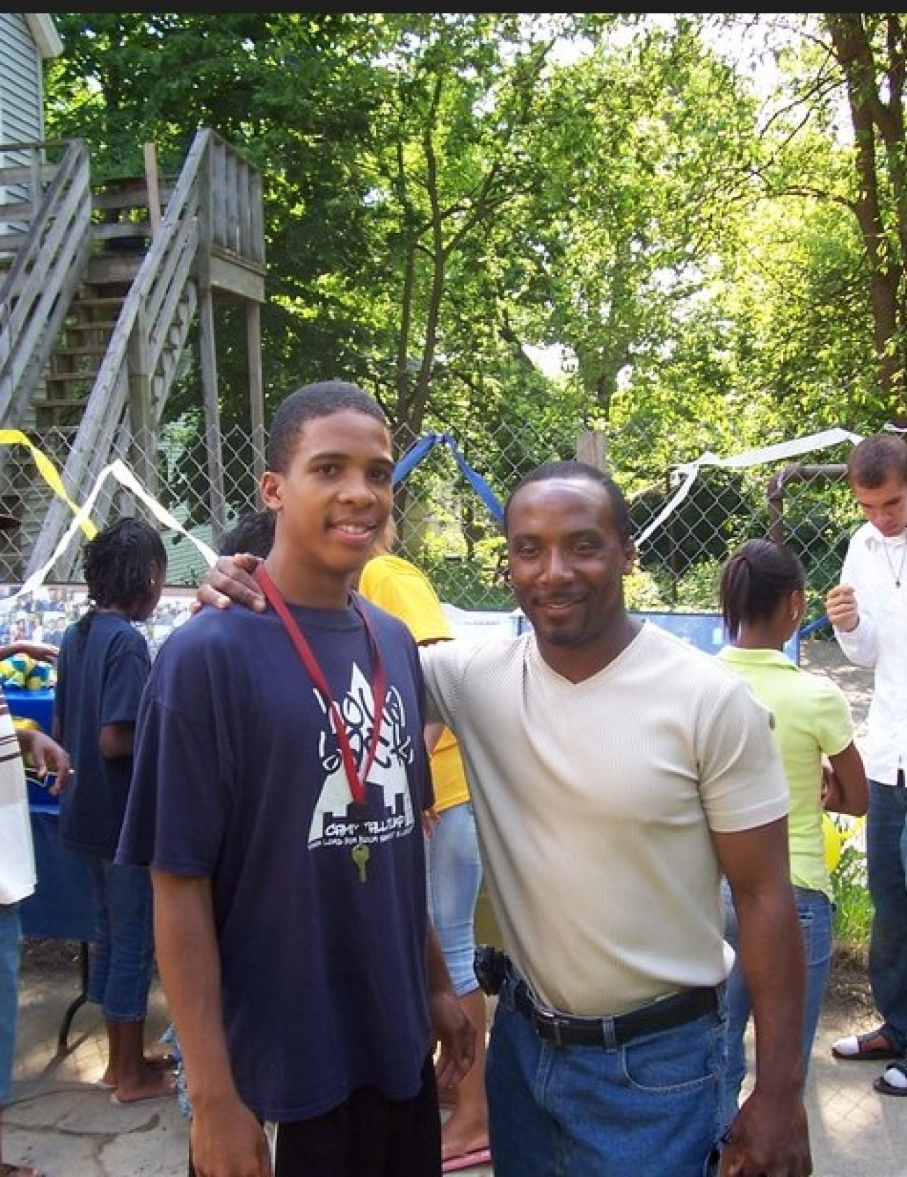 coach standing next to a player