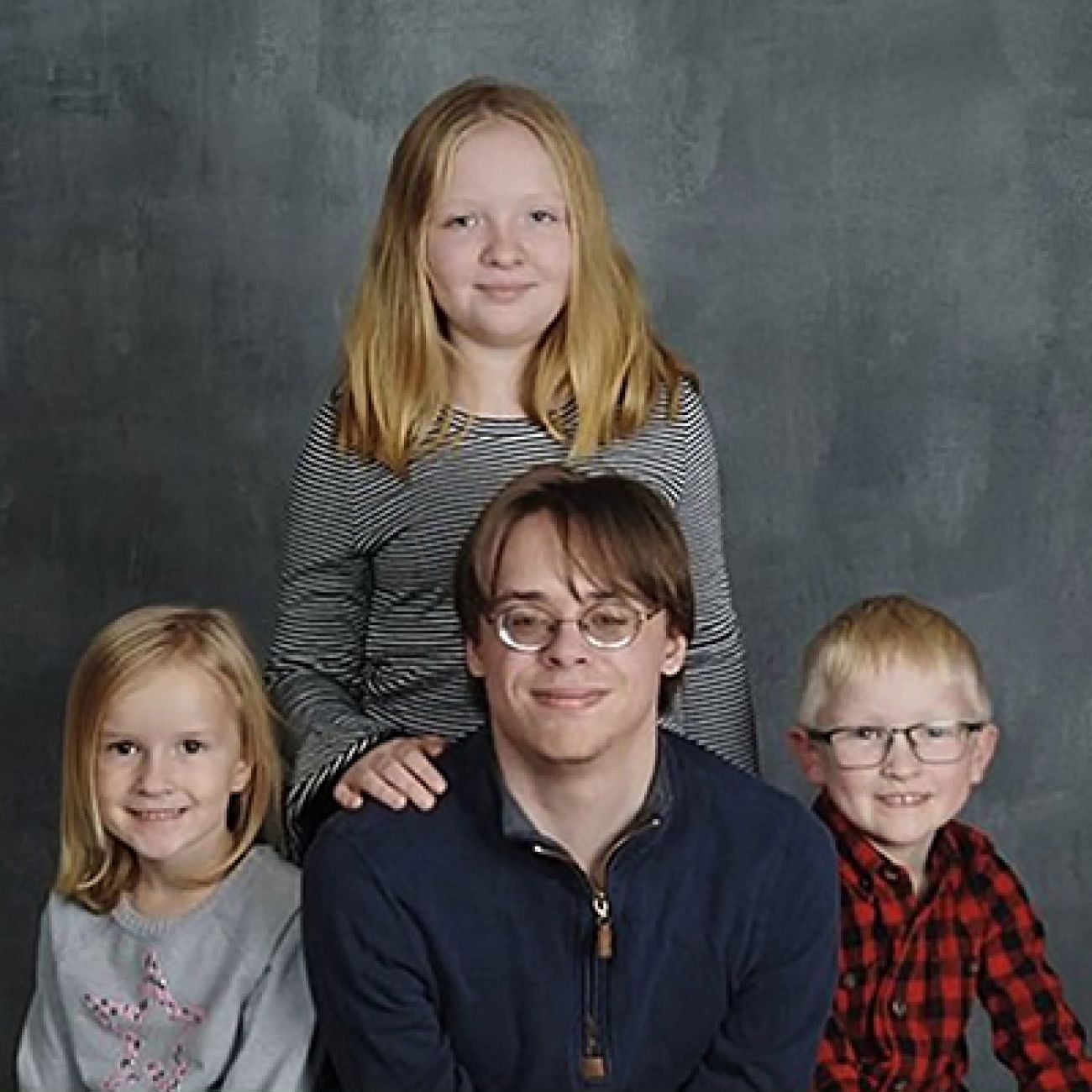 a family photo with a grey background