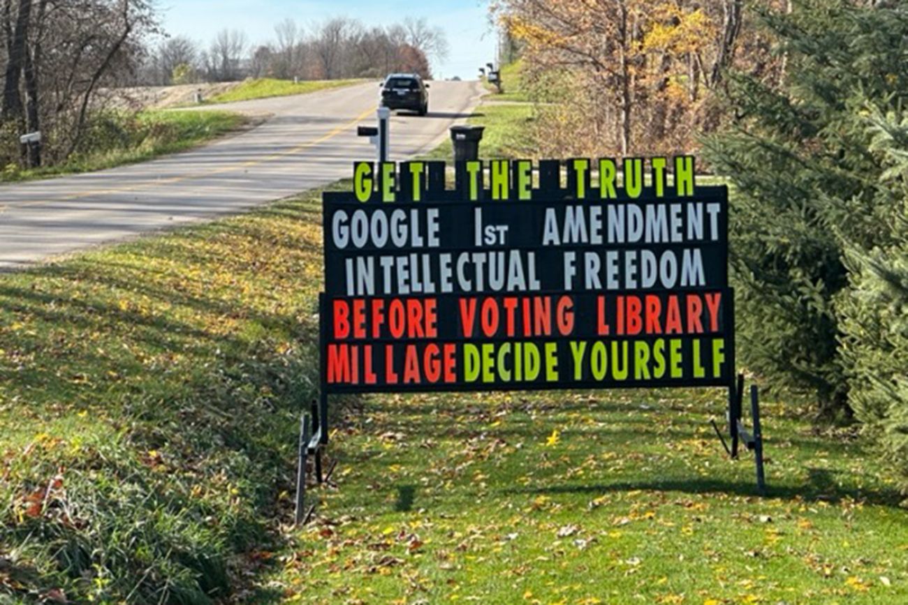 sign “Google 1st Amendment (and) Intellectual freedom before voting library millage.”