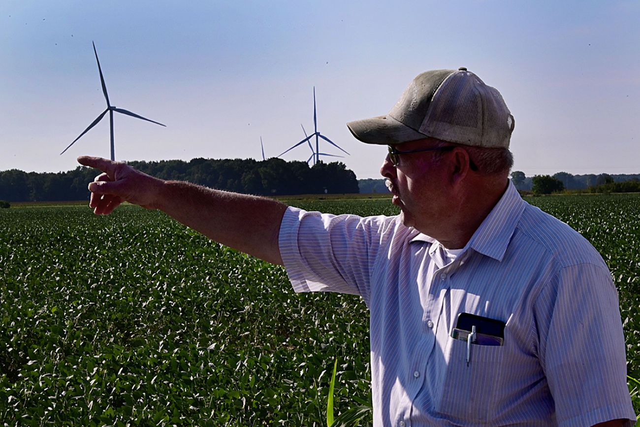 man with wind turbines in the background