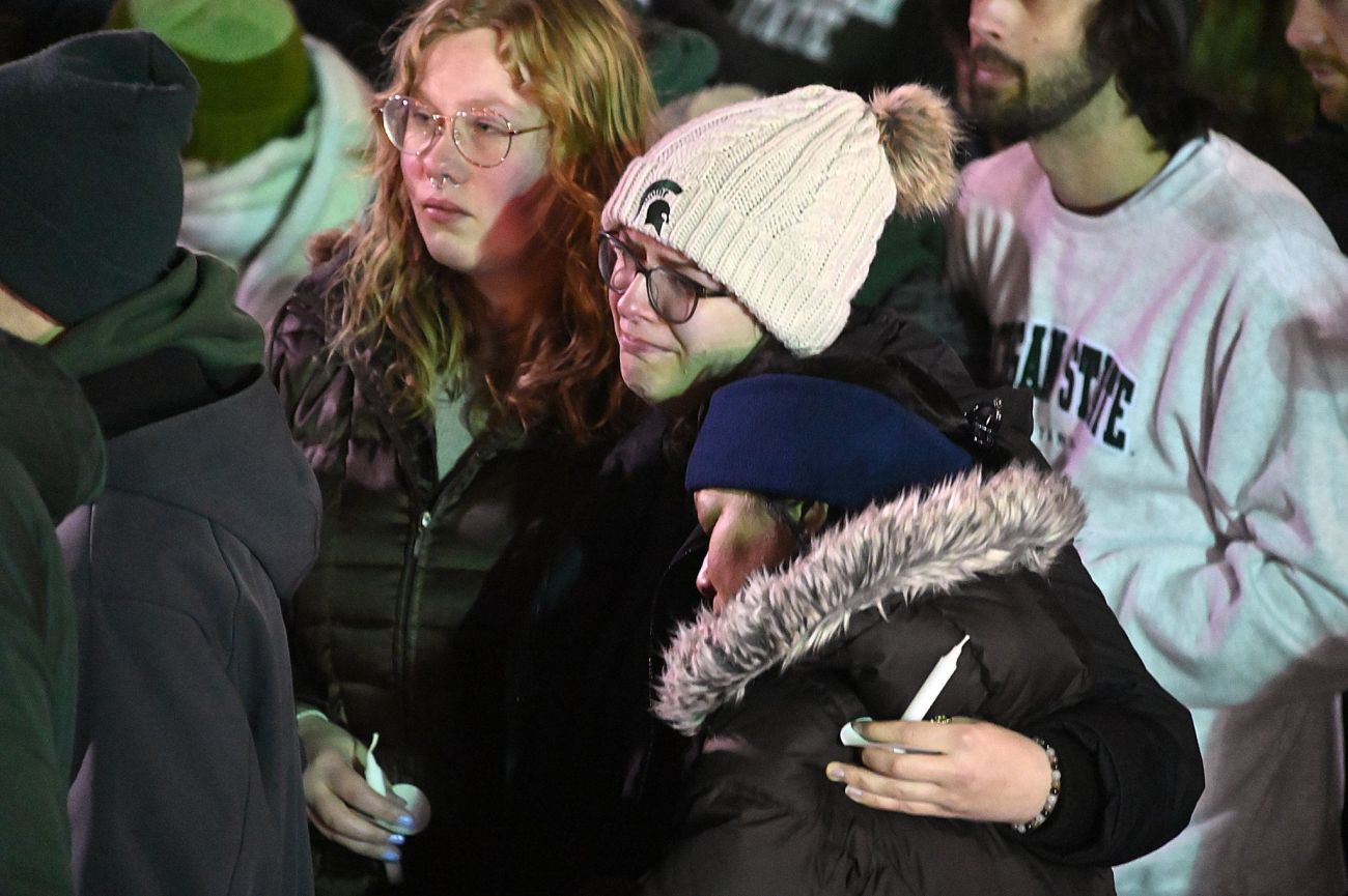 two people hugging each other at vigil