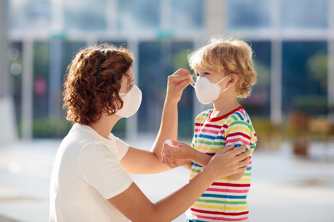 mom with mask on put mask on child