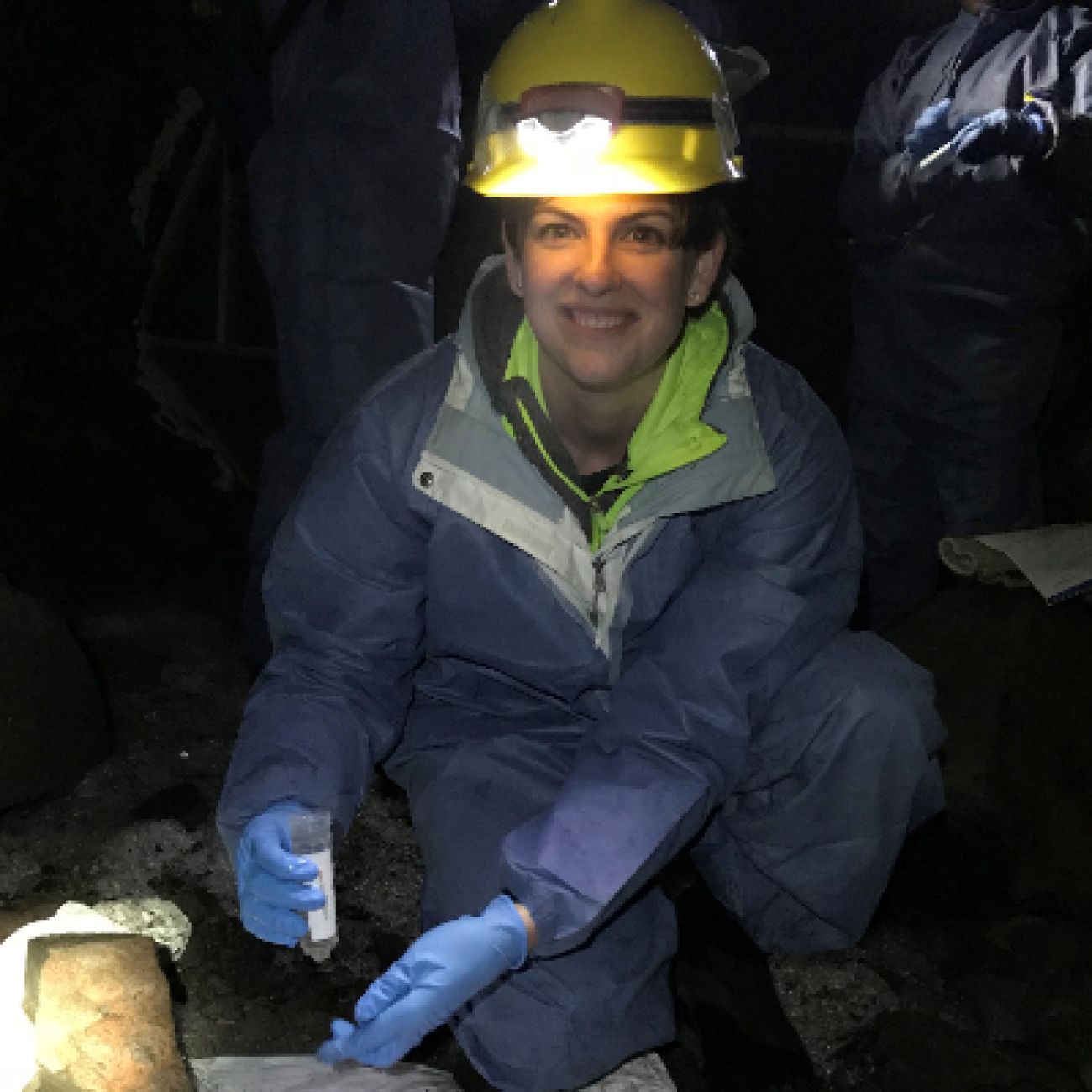 Woman in hard hat in a cave