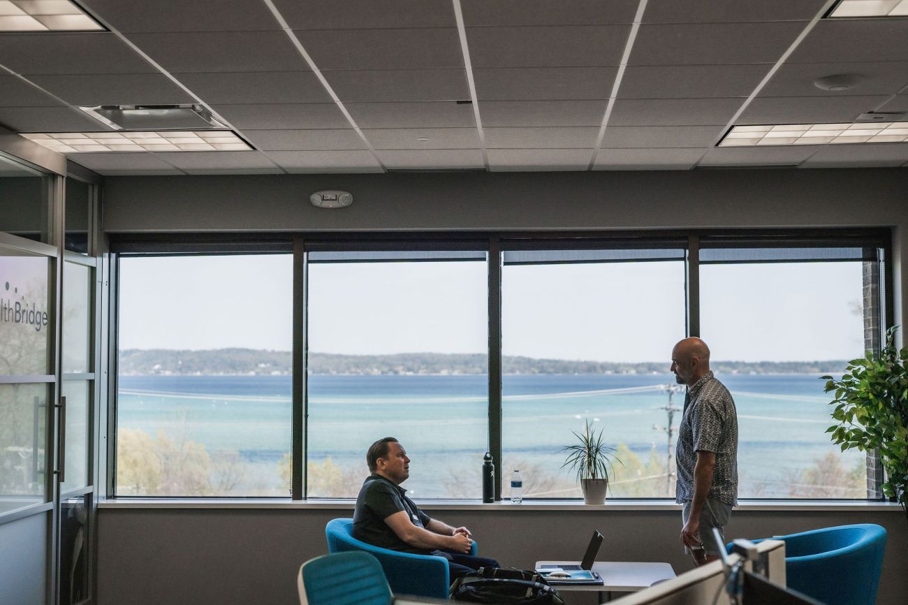 an open space office. In the window, you can see Grand Traverse Bay