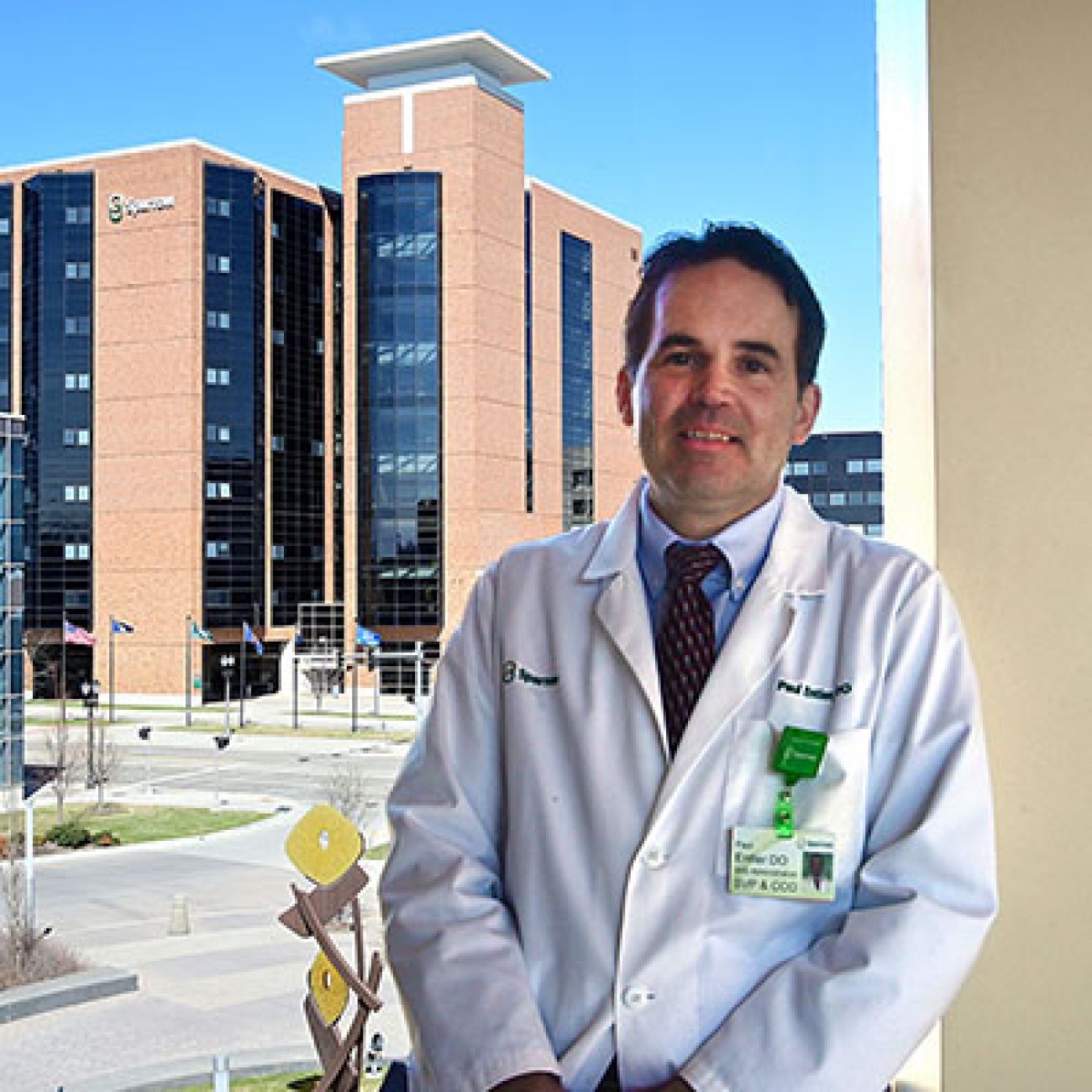 Dr. Paul Entler, chief clinical officer at Sparrow hospital, posing in front of a window