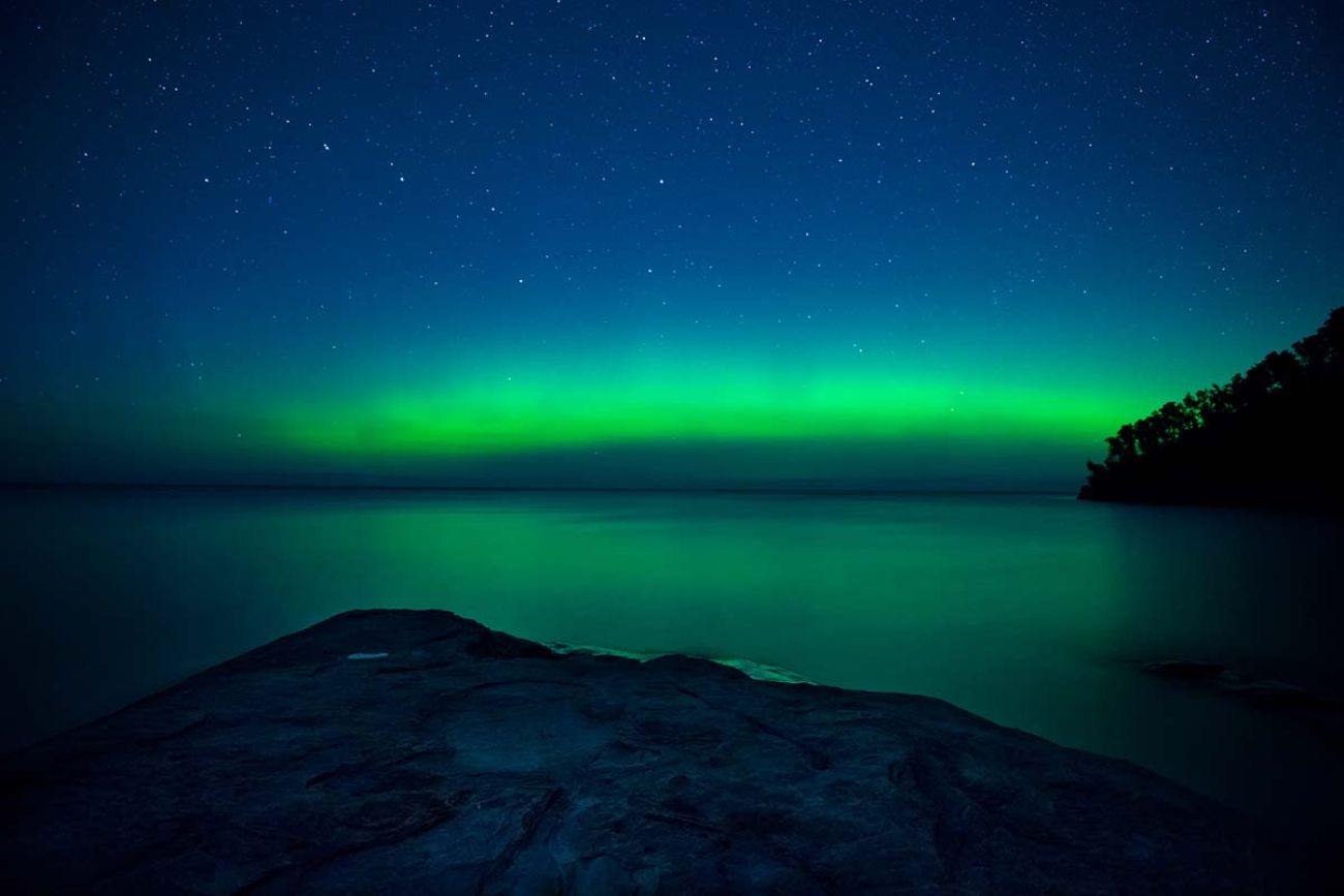 Northern lights appear over Miner's Beach in the pictured Rocks National Lakeshore.