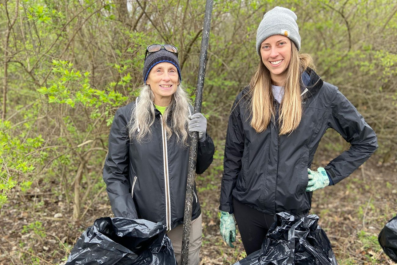 two women near trash bags outside