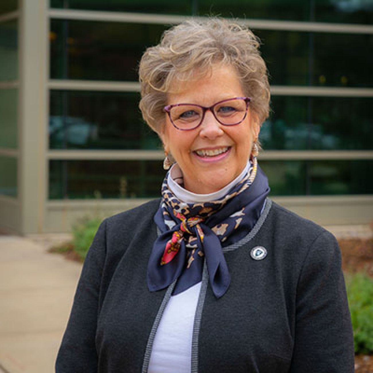 Leigh Small, dean of Michigan State University’s College of Nursing, standing in front of the window