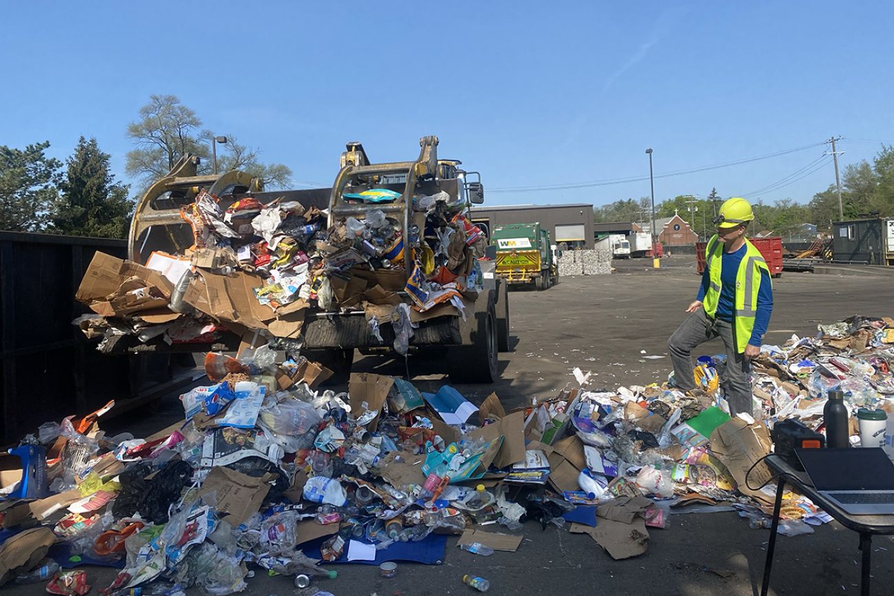 a truck with a bunch of trash surrounding it