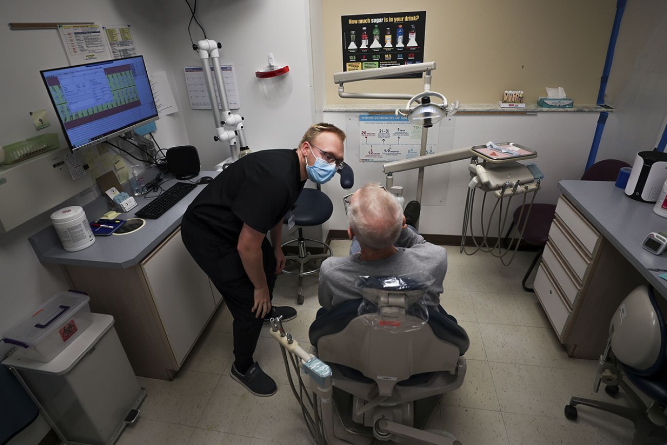 Brendan VanDeWeghe talking to a patient 