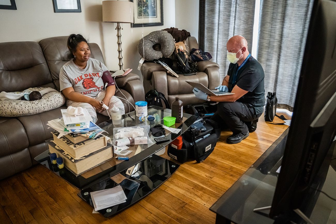 paramedic checking vitals in Kayla Sturkey's living room