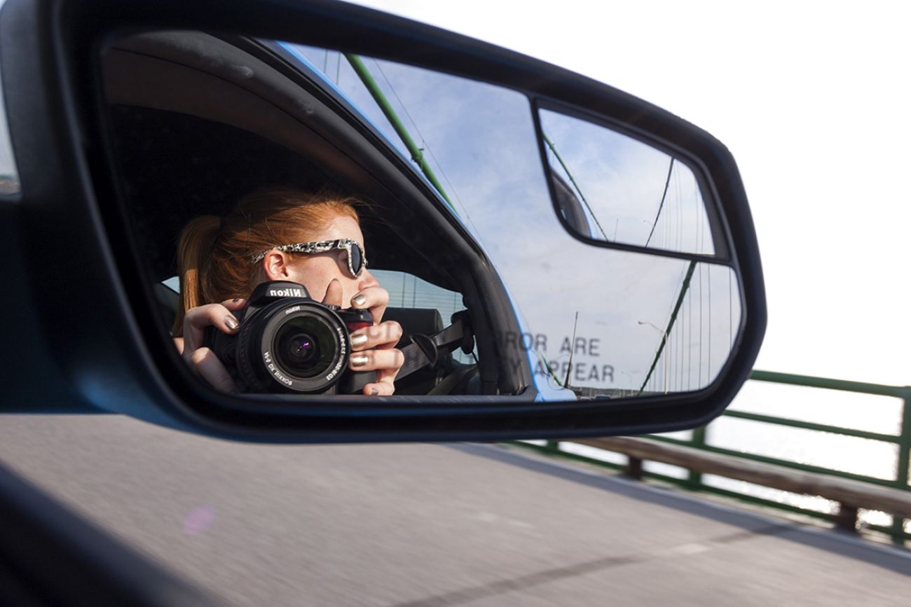 Mallory McMorrow in the side mirror of car