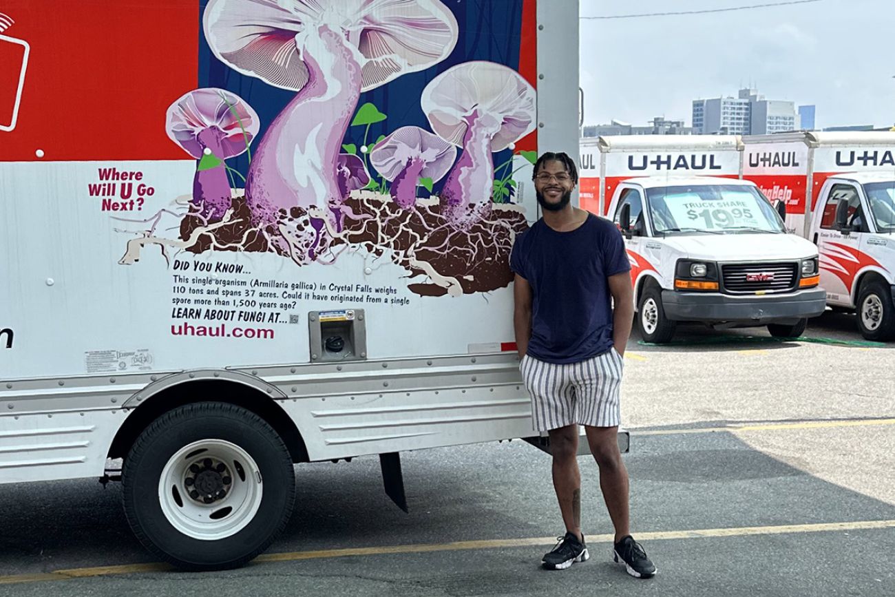 young man standing next to U-Haul truck