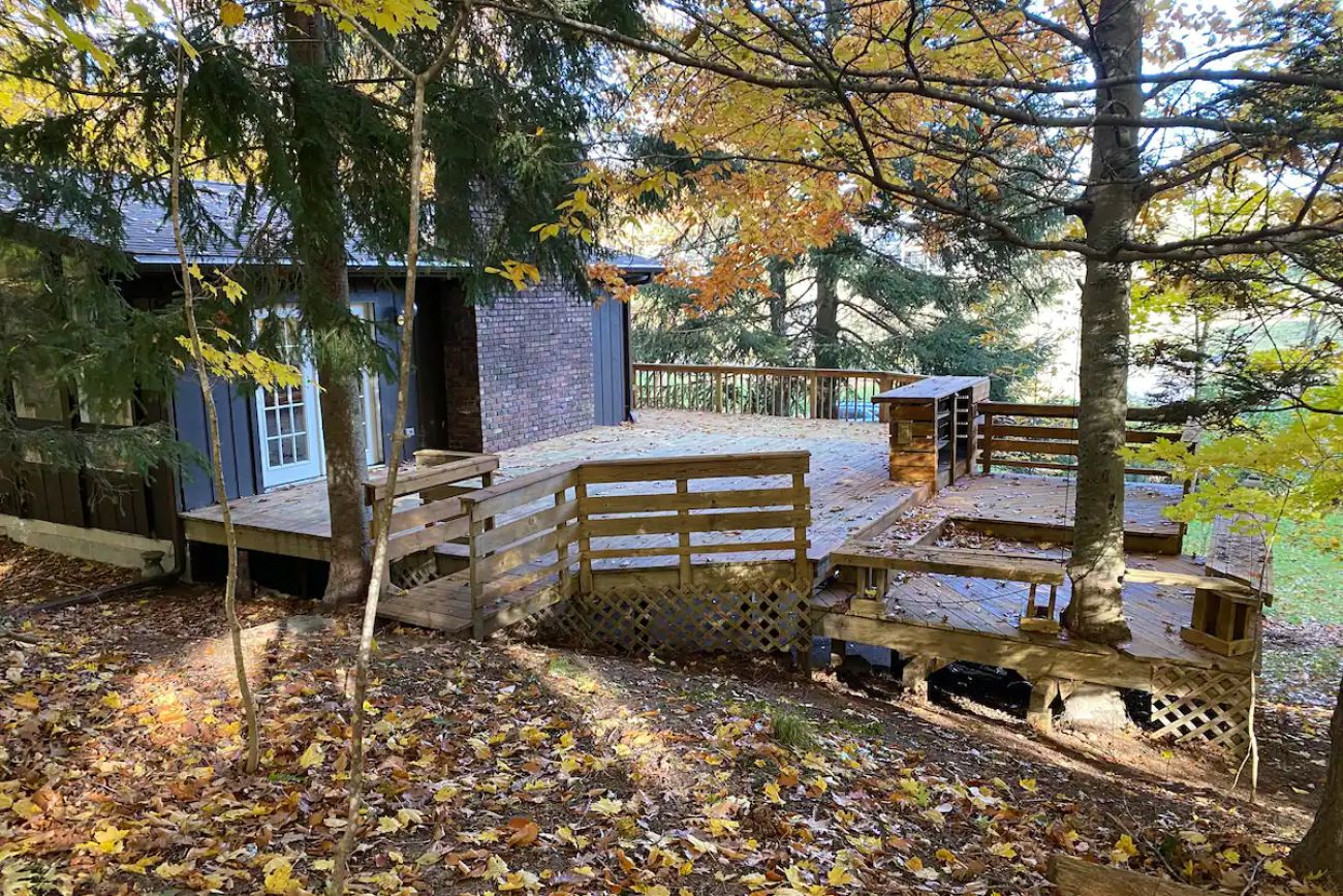 a home with a large deck surrounded by deck