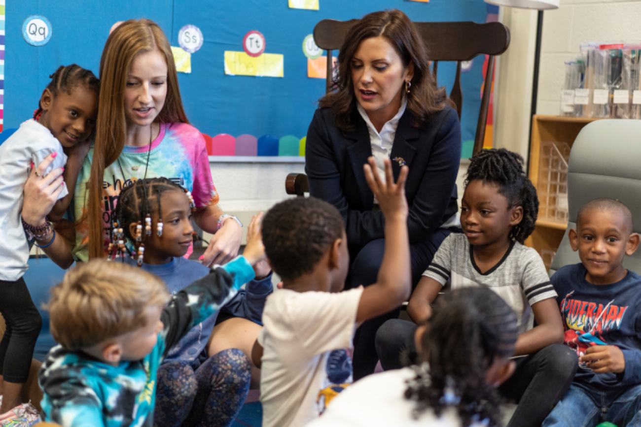 Governor Gretchen Whitmer sits with students in a classroom
