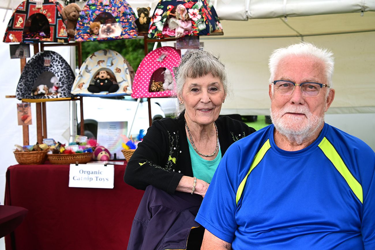 Robert Williams and his wife standing in front of their craft display