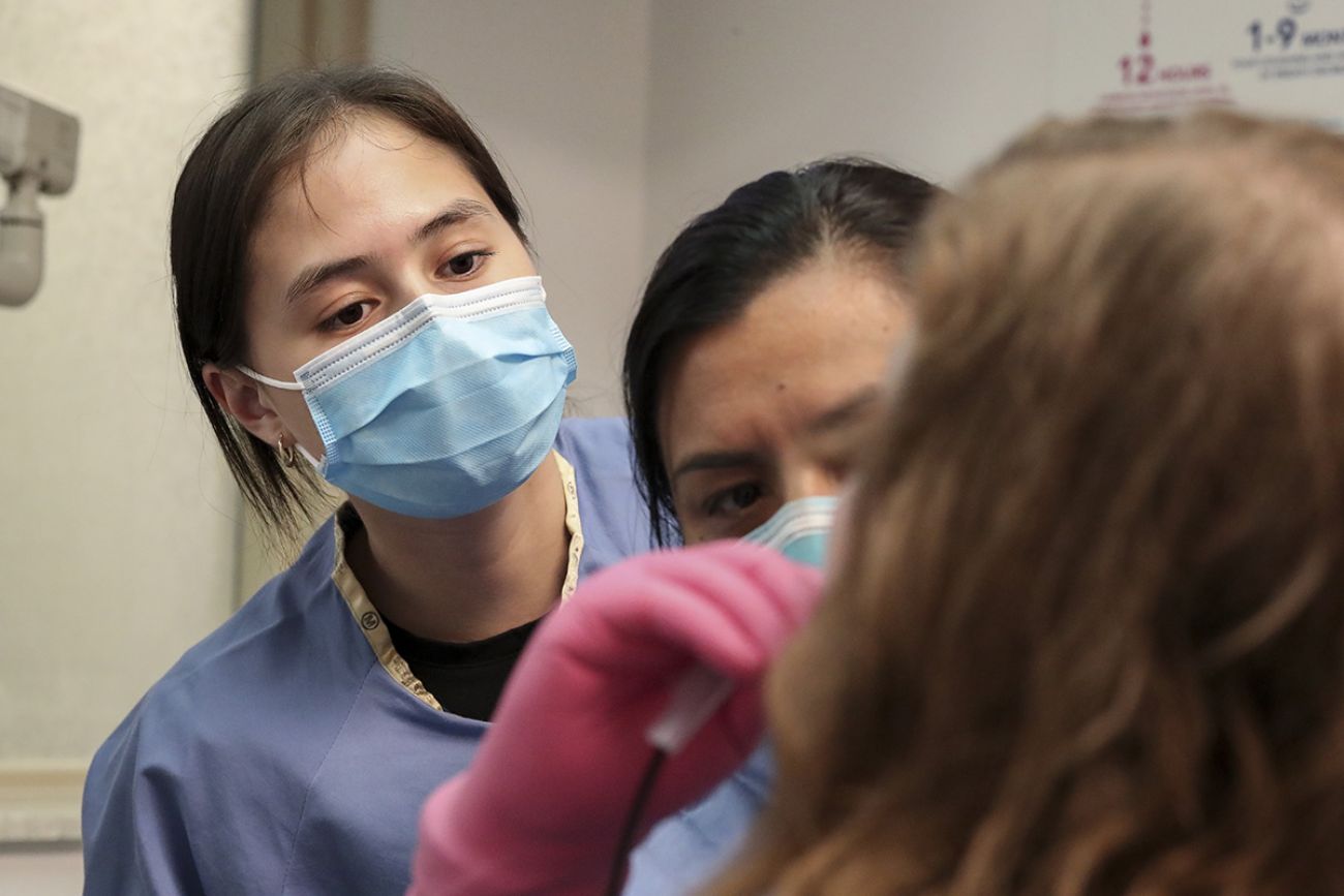 two people looking into a patient mouth