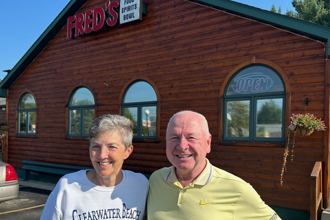 Kathy Bair and Ed Roginski standing in front of Fred’s 