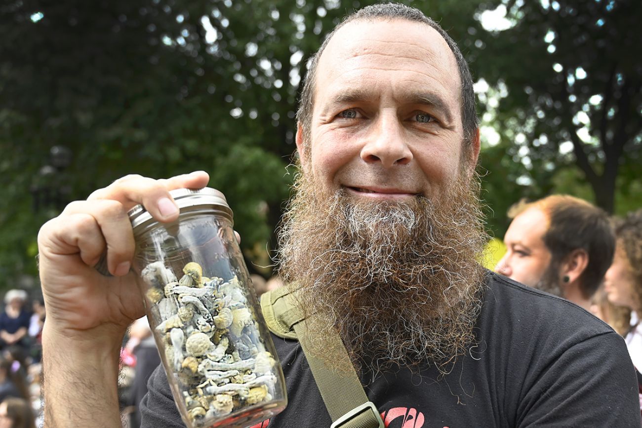 Josh Man holds a jar of mushrooms