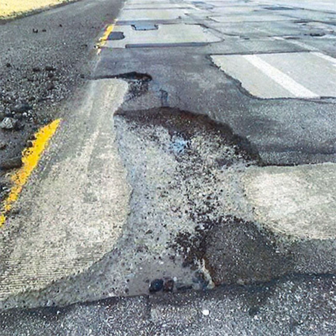 many potholes on a road